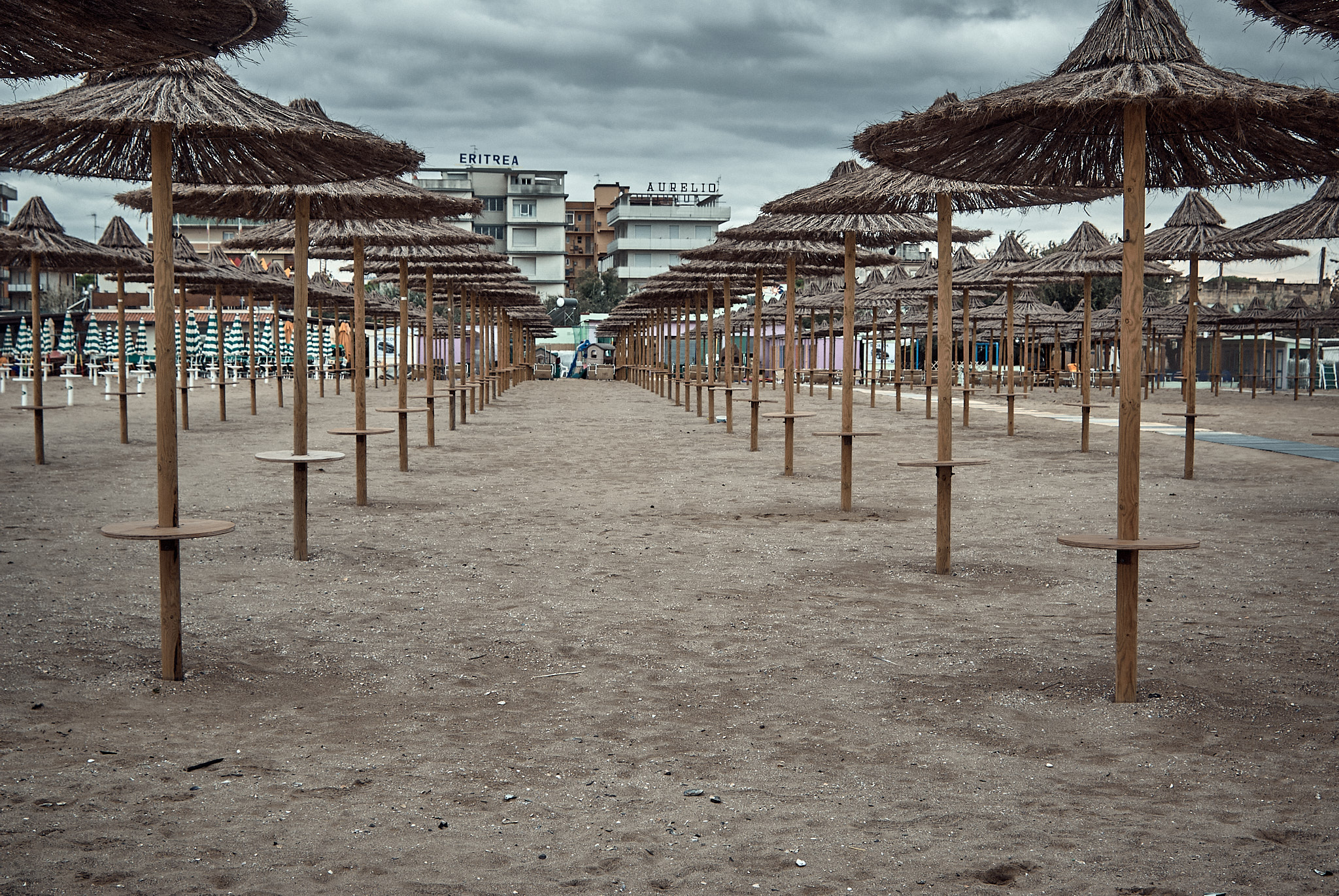 Rimini beach at the end of the season, with umbrellas set up in the beach resort lido
