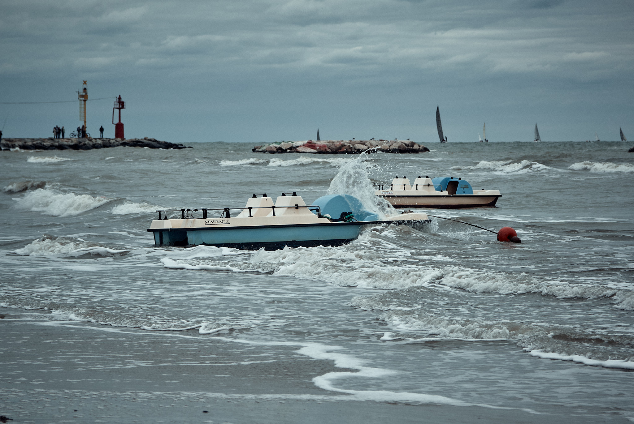 Rimini, paddle boats adrift on the sea, tossed by the waves