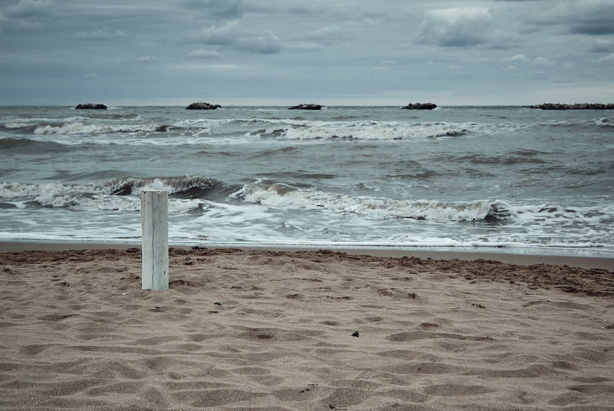 Rimini beach and Adriatic Sea, with a white pole on the beach
